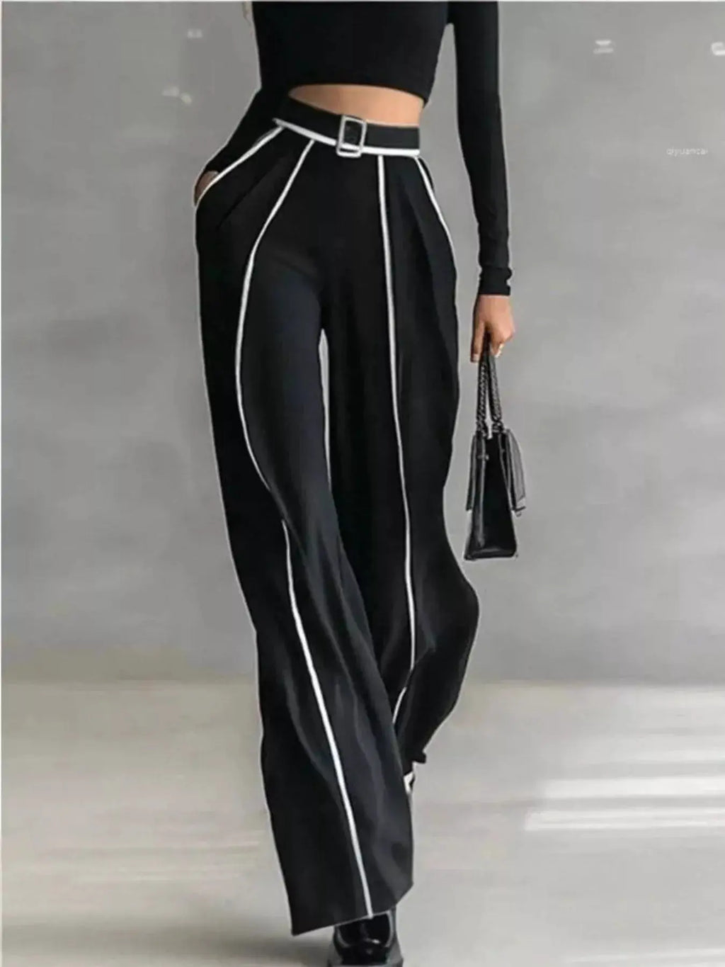 Turtleneck Long Sleeve Top and Contrast Pants Set in black with white piping and belt; model carries a small black handbag.
