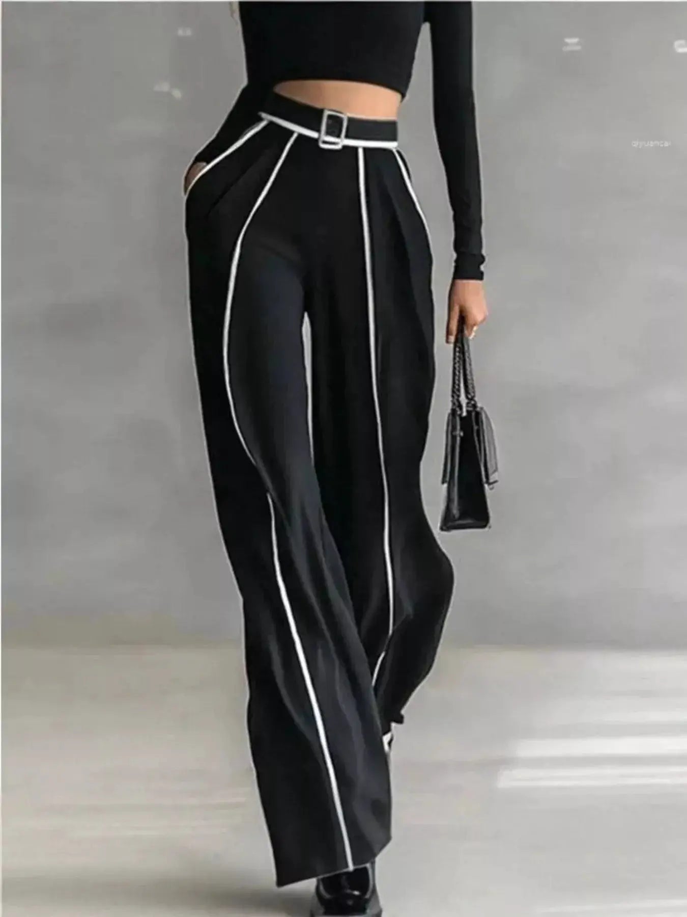Turtleneck Long Sleeve Top and Contrast Pants Set in black with white piping and belt; model carries a small black handbag.