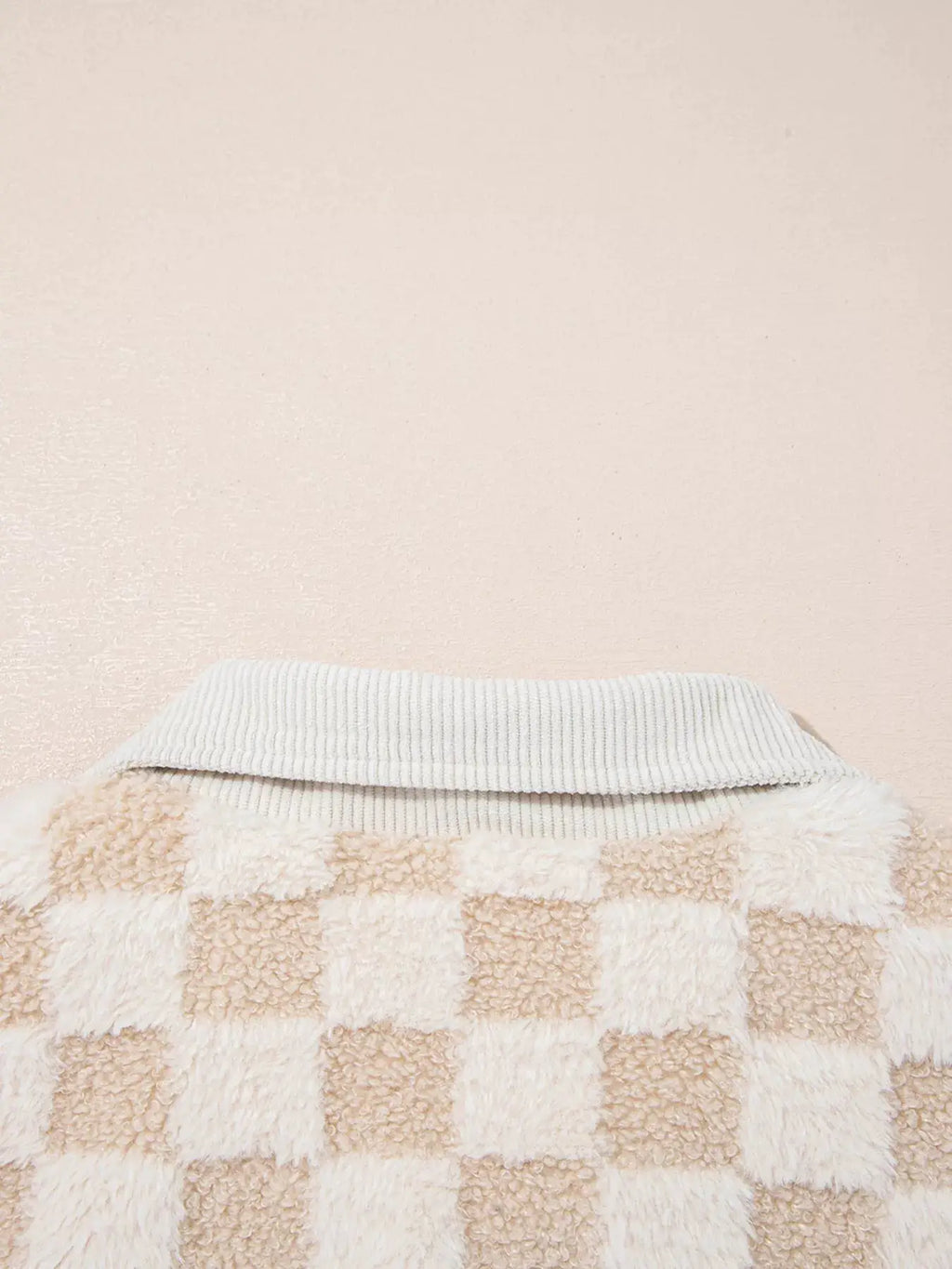 Checker sherpa patchwork zip-up jacket with beige and ivory squares and a gray ribbed collar