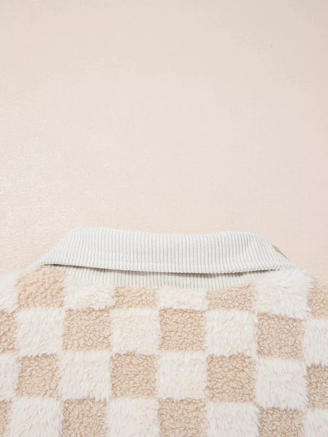 Checker sherpa patchwork zip-up jacket with beige and ivory squares and a gray ribbed collar