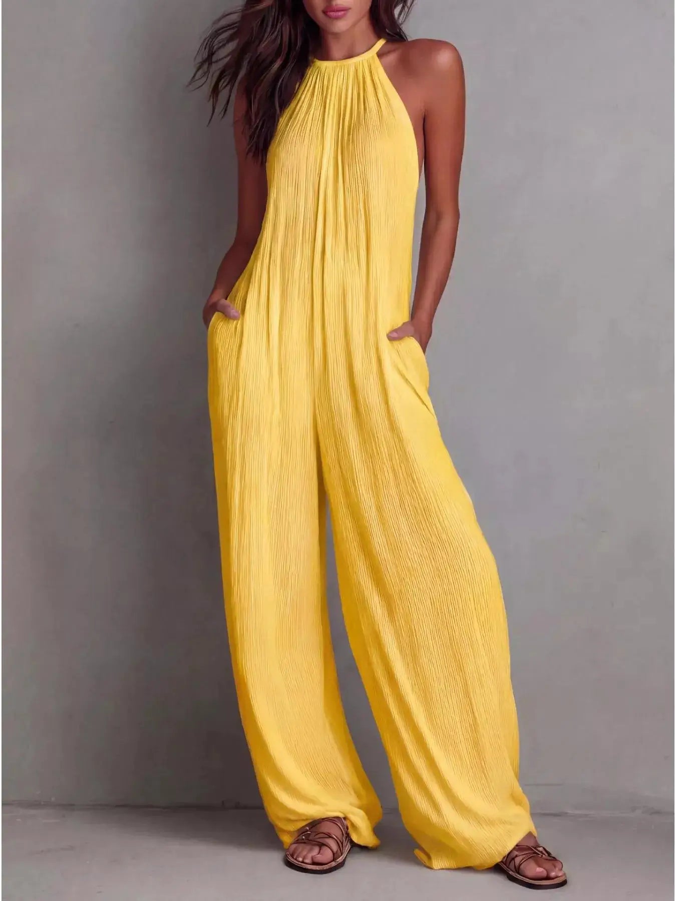 Sleeveless wide-leg yellow jumpsuit with pleated fabric, pockets and zipper