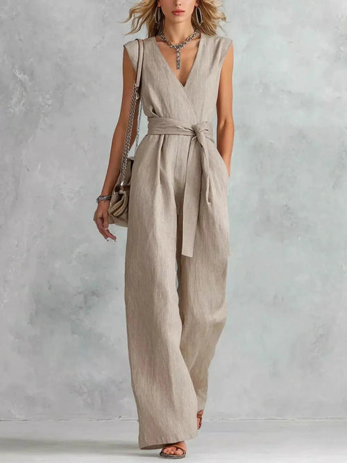 Sleeveless wide-leg jumpsuit in beige linen, with self-tie waist belt and wrap V-neck