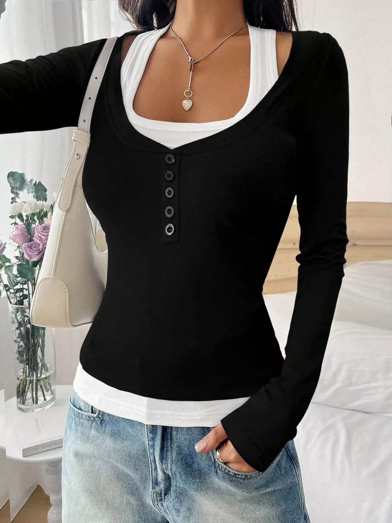Scoop Neck Long Sleeve T-Shirt in black with button-front placket; worn with a white inner layer and light denim jeans.