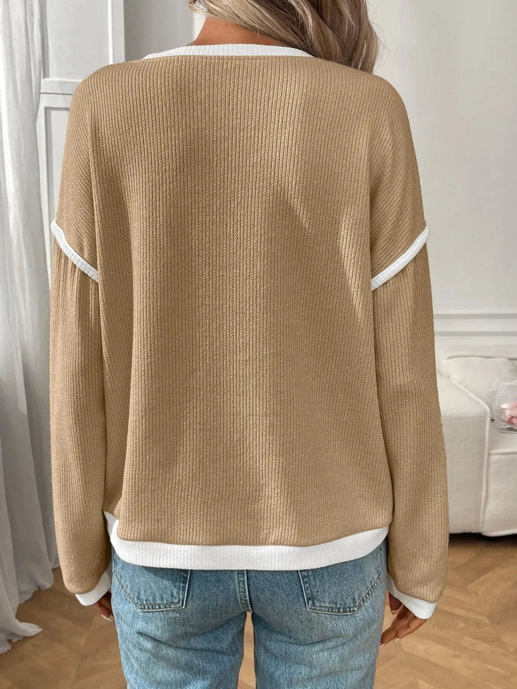 Ribbed beige knit long-sleeve top with white contrast trim