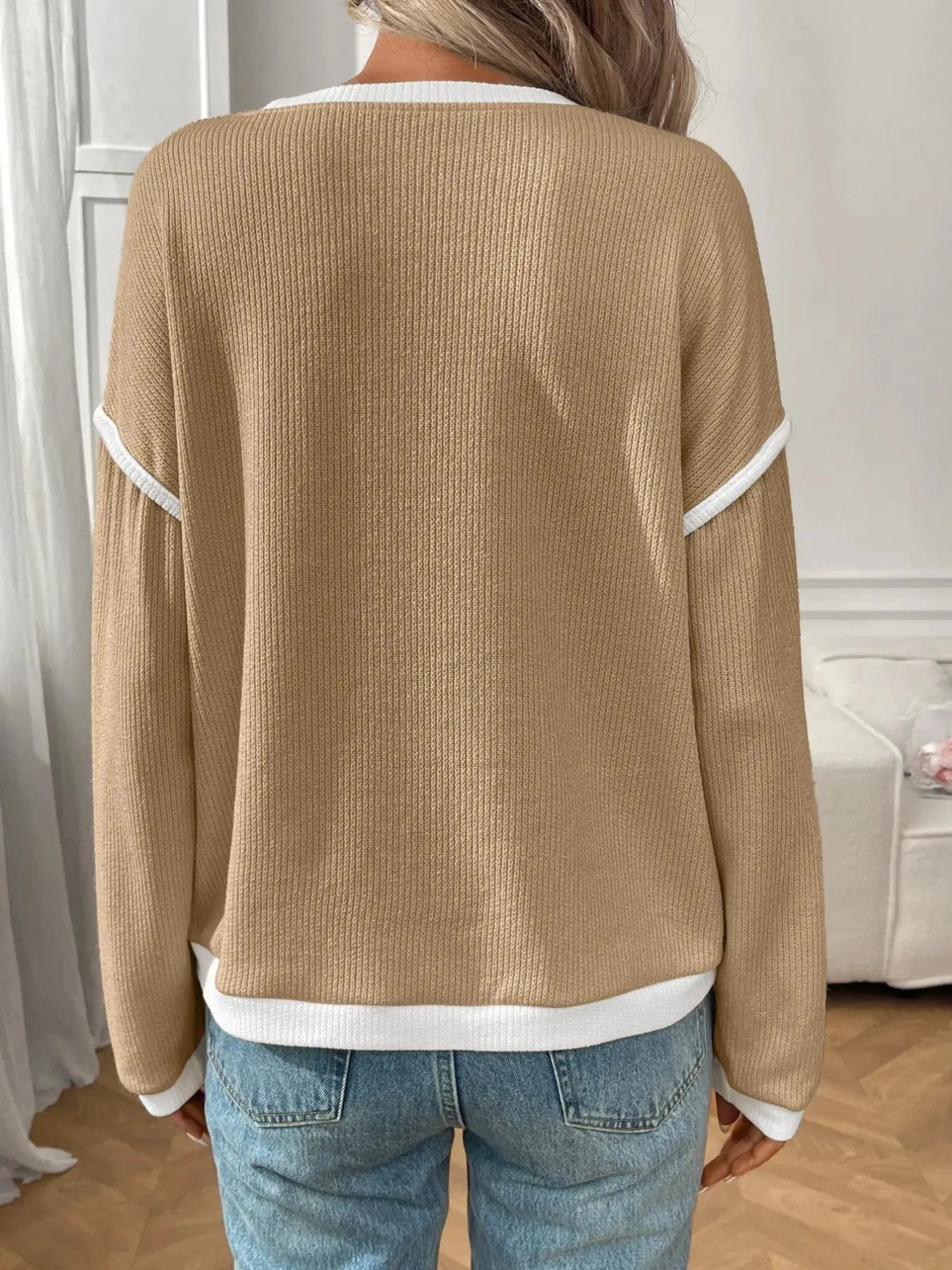 Ribbed beige knit long-sleeve top with white contrast trim