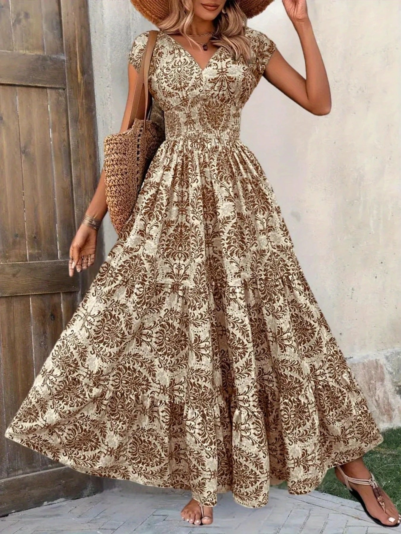 Printed cap-sleeve maxi dress in beige-brown damask print with tiered skirt and smocked waist.