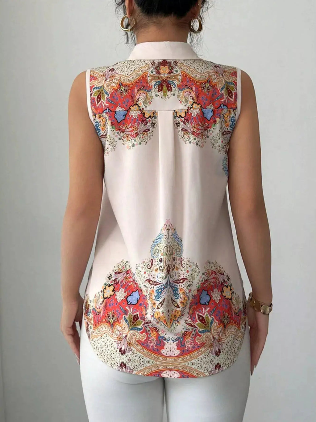 Button Up Sleeveless Shirt by Belle Bijouix with white base and colorful paisley pattern across the back