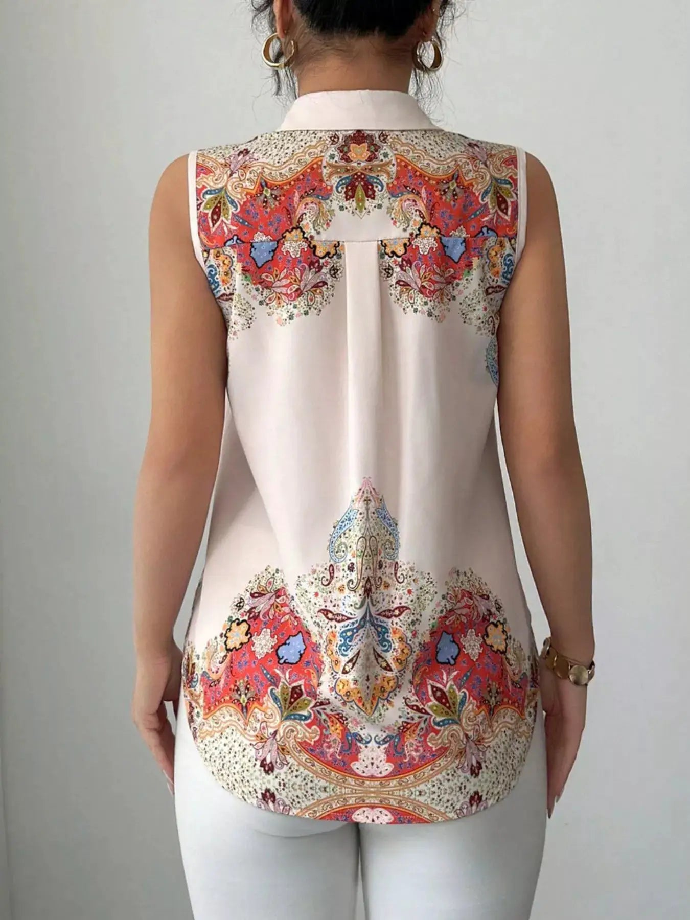 Button Up Sleeveless Shirt by Belle Bijouix with white base and colorful paisley pattern across the back