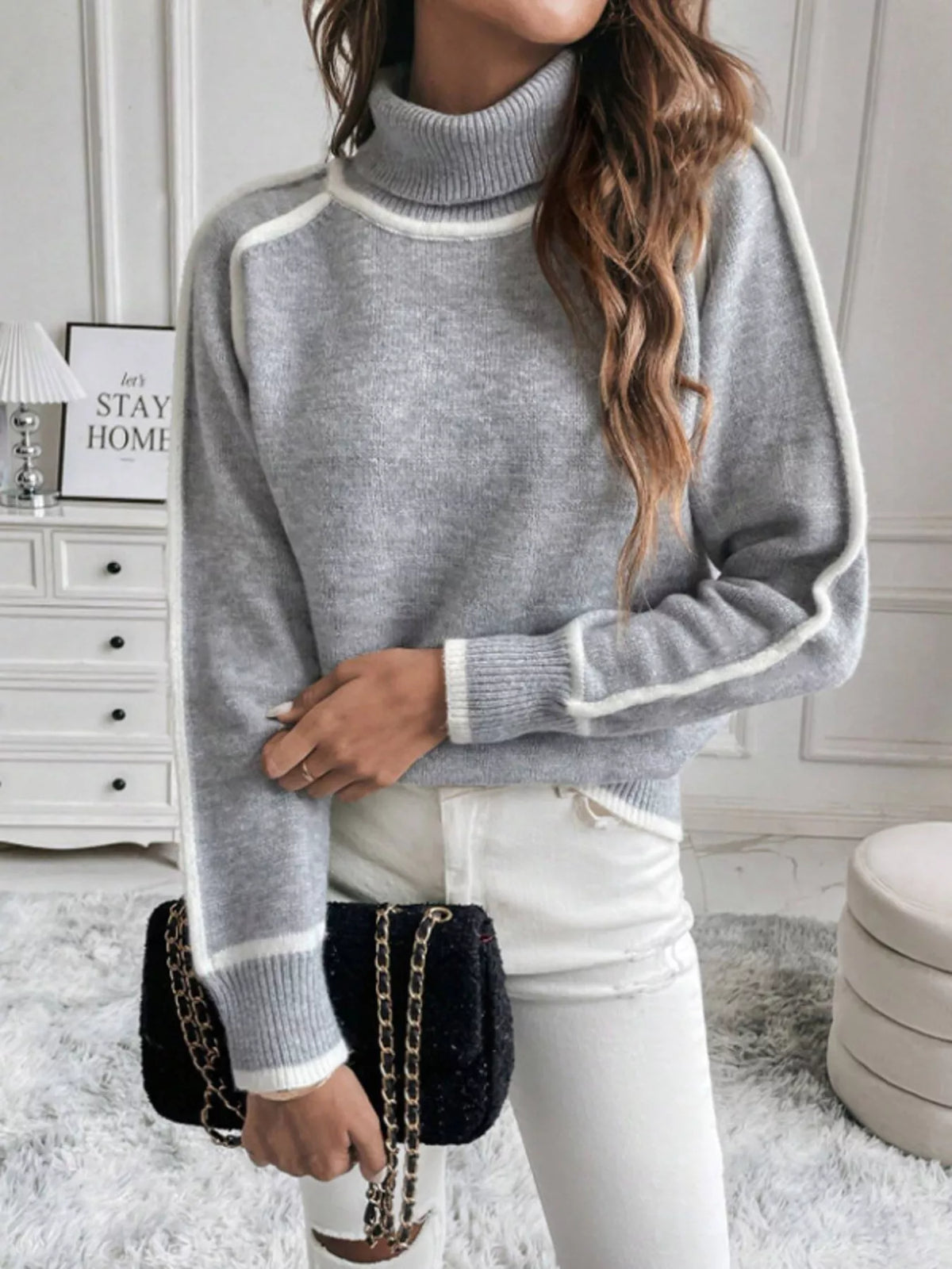 Gray turtleneck sweater showing sleeve trim and ribbed hem