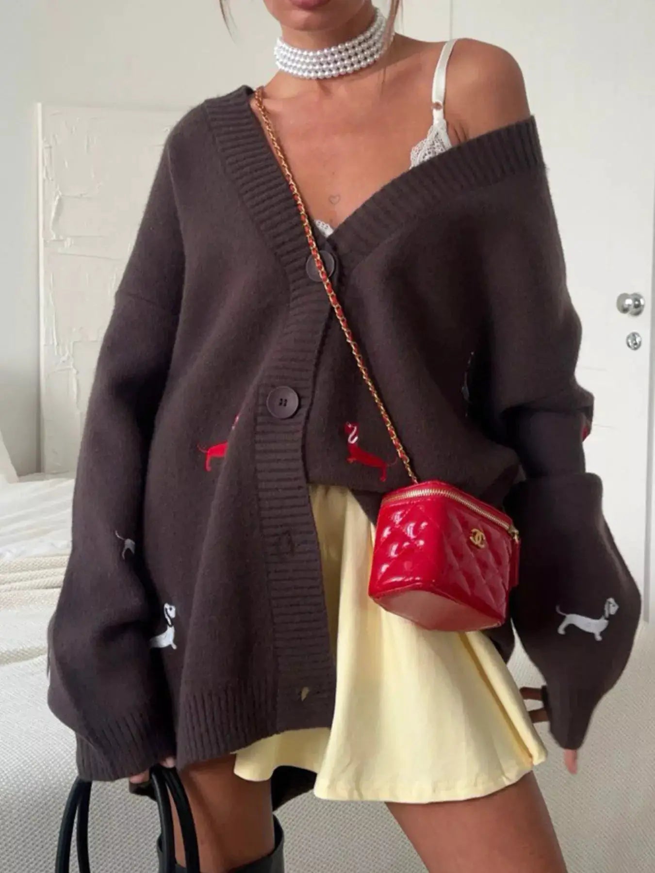 Embroidered button-up cardigan, brown knit by Belle Bijouix; paired with a red Chanel bag