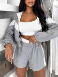 Zip-Up long-sleeve outerwear and shorts set in light gray with white panels.