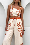 Smocked square-neck cami and pants set in cream with rust-orange floral print; wide-leg pants with drawstring waist