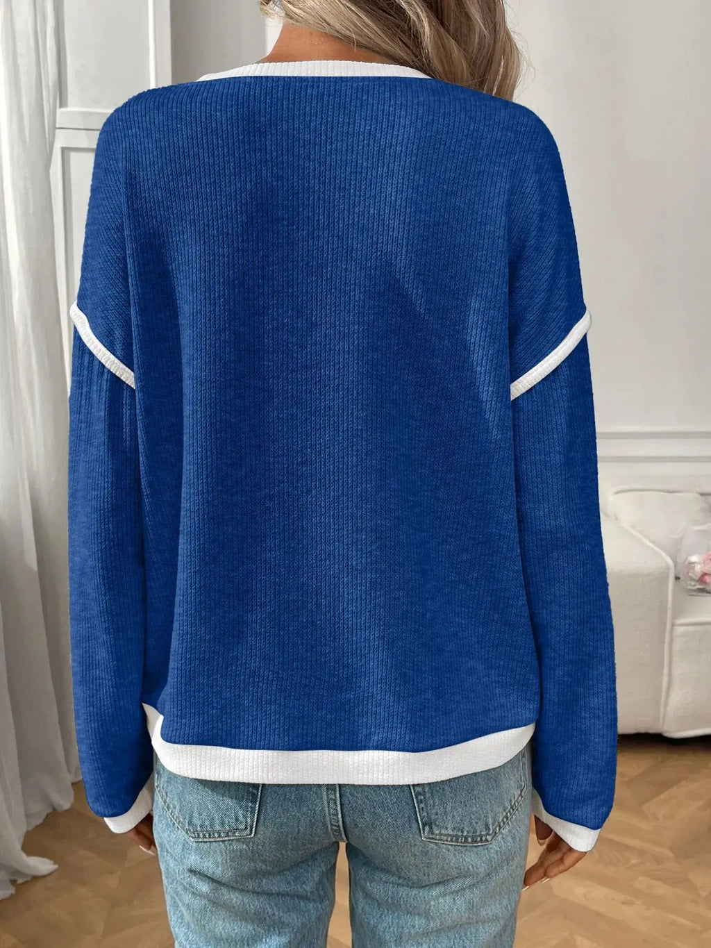 Ribbed contrast-trim long sleeve top in bright blue knit with white neckline, cuffs, and hem trim; back view