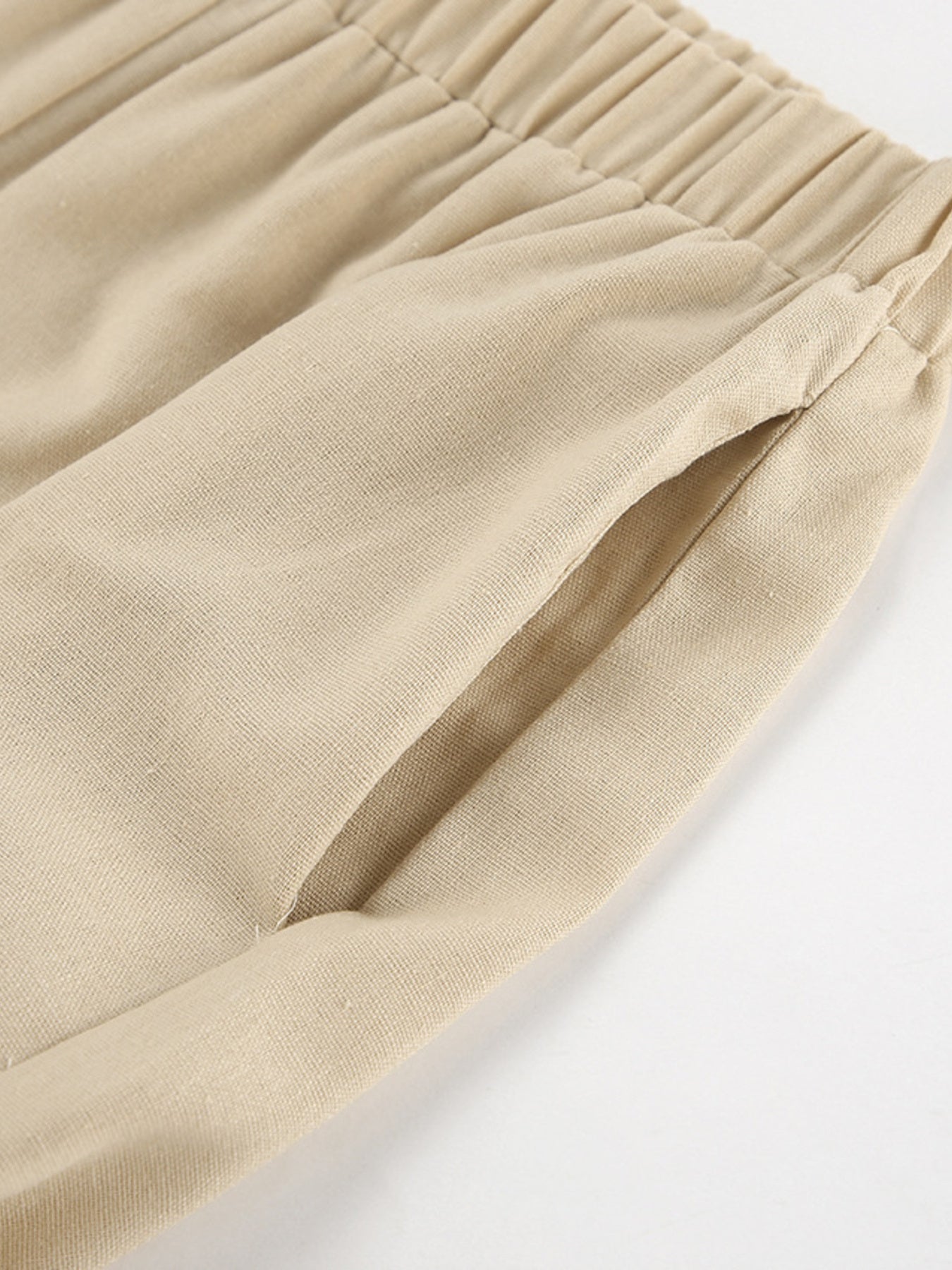 Belle Bijouix beige sleeveless crop top and slit pants set; elastic waistband detail.