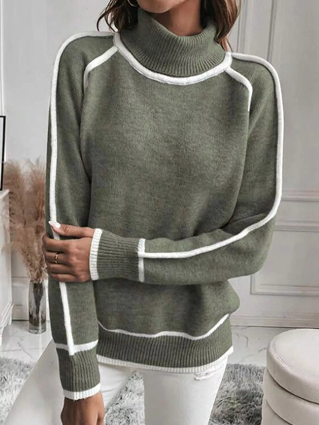 Military green turtleneck sweater showing white sleeve trim and ribbed hem