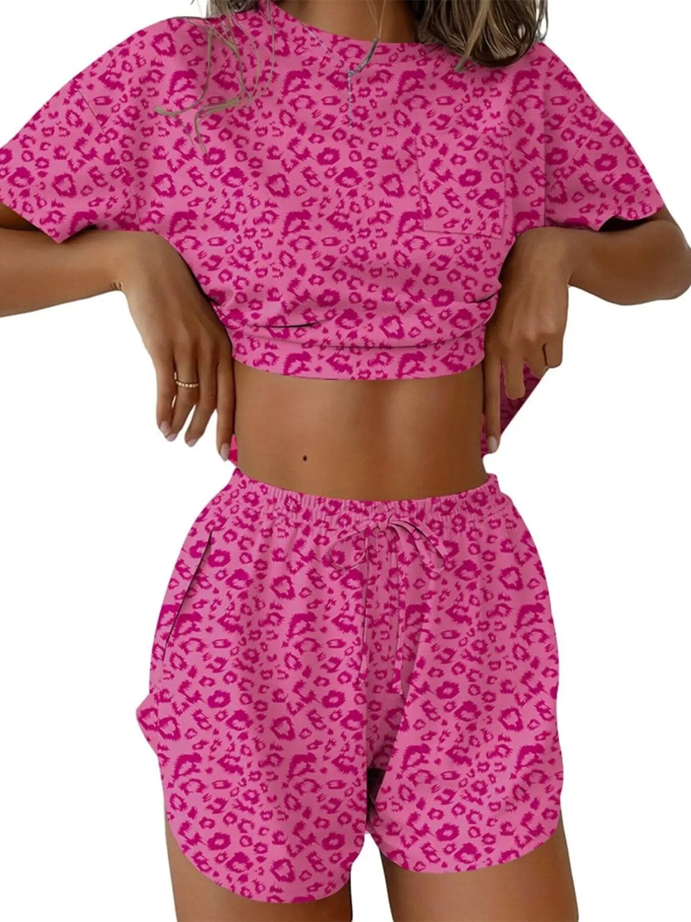 Printed round-neck tee and shorts set in pink leopard print; cropped top with short sleeves and drawstring shorts.