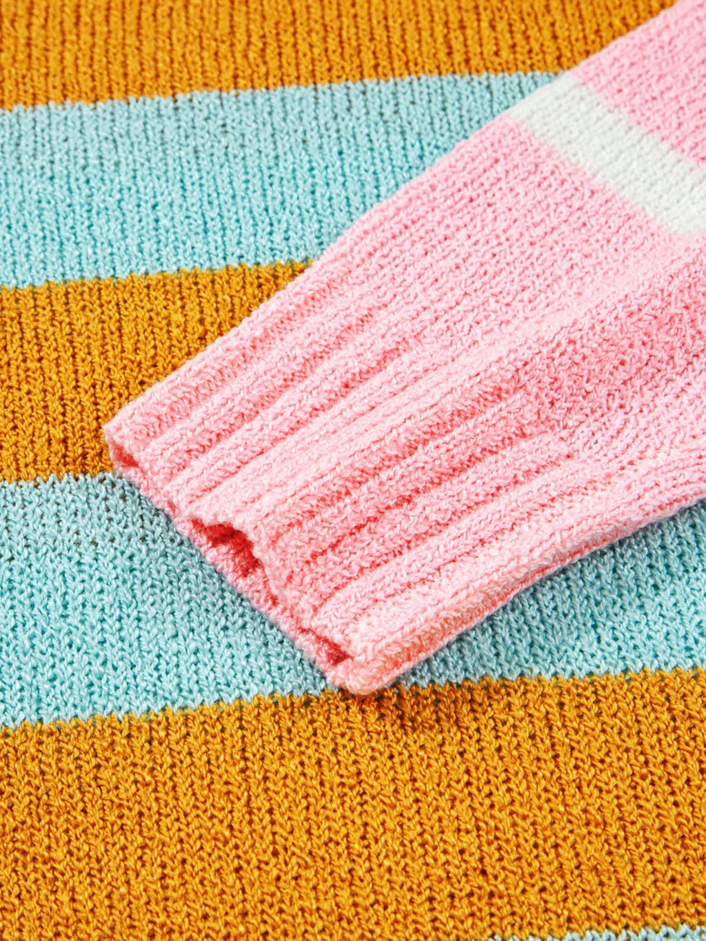 Color block striped knit sweater with pink ribbed cuff and orange teal stripes
