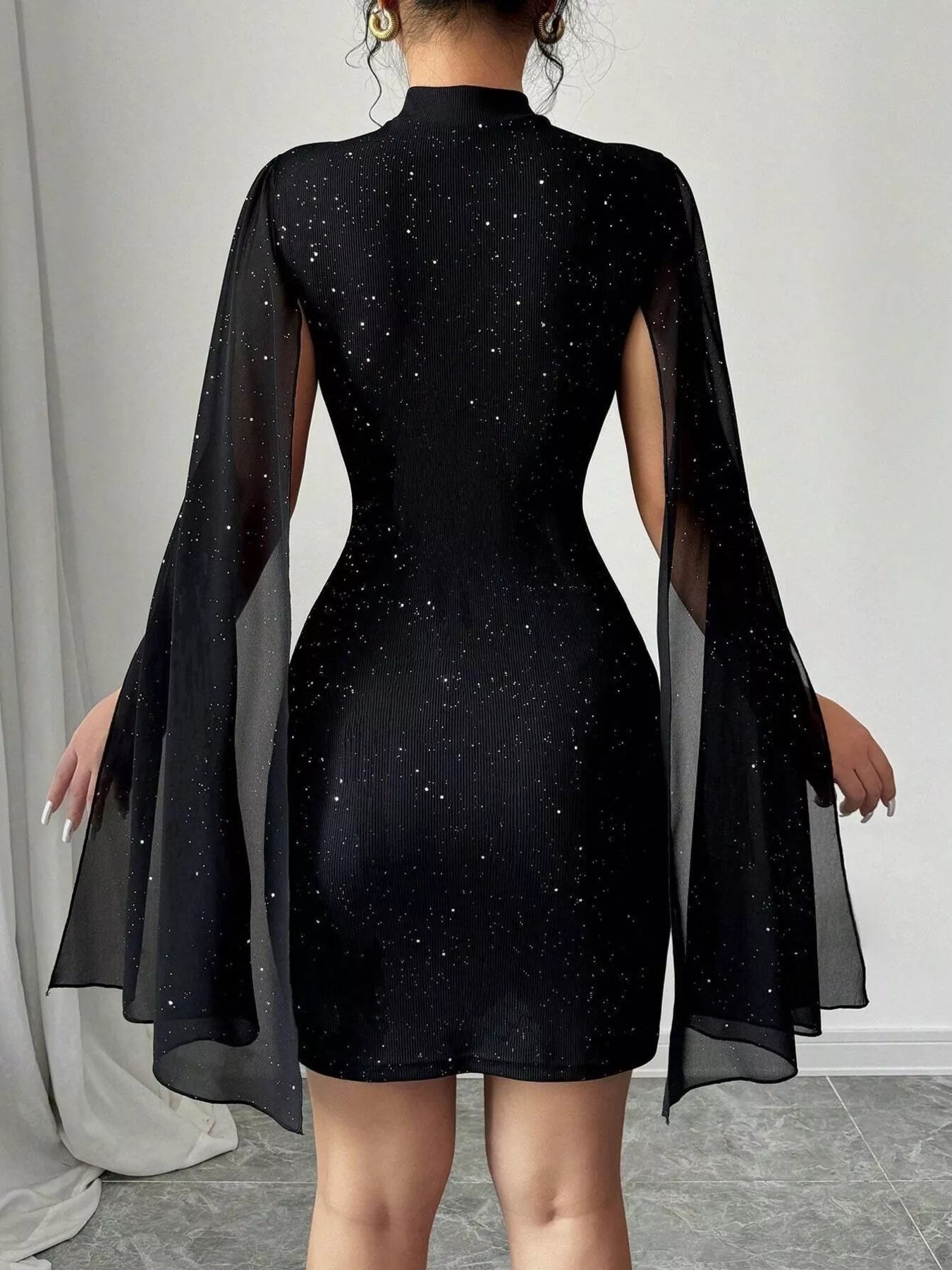 Cutout Bodycon Mini Dress with Cape Sleeves by Belle Bijouix in black glitter fabric
