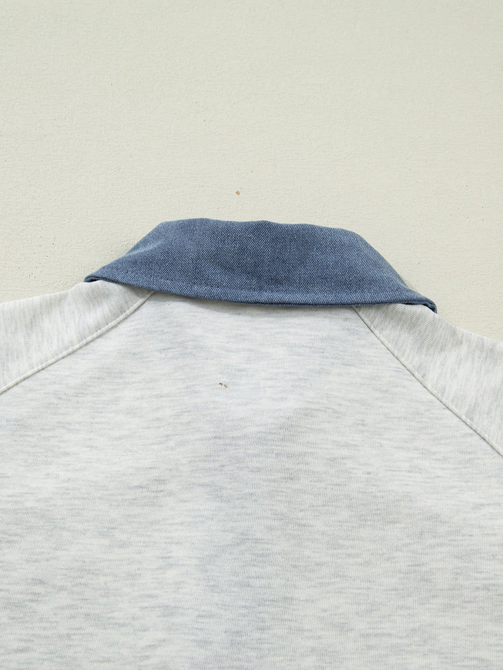 Contrast Trim Button Detail Top with blue denim collar on light gray fabric by Trendsi