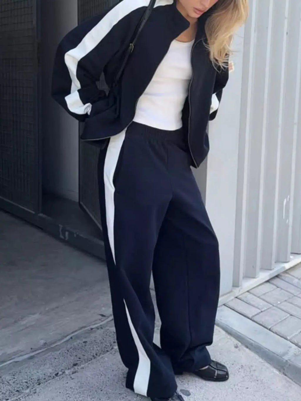 Two-Piece Zip-Up Long-Sleeve Activewear Set in navy with white side stripes; jacket and matching pants.