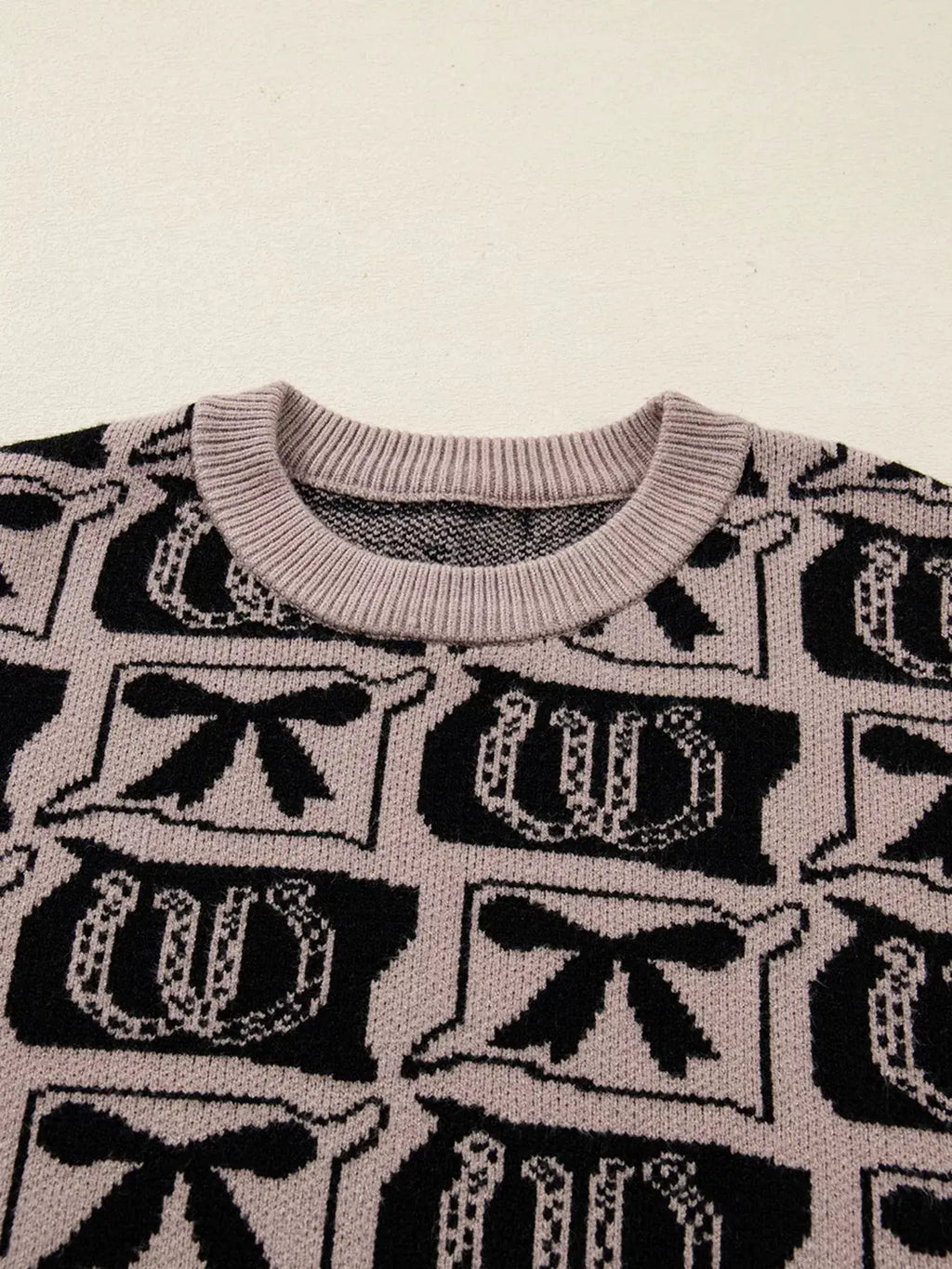 Bows & Horseshoes Pattern Round Neck Sweater, pink-beige knit with black bow and horseshoe motifs