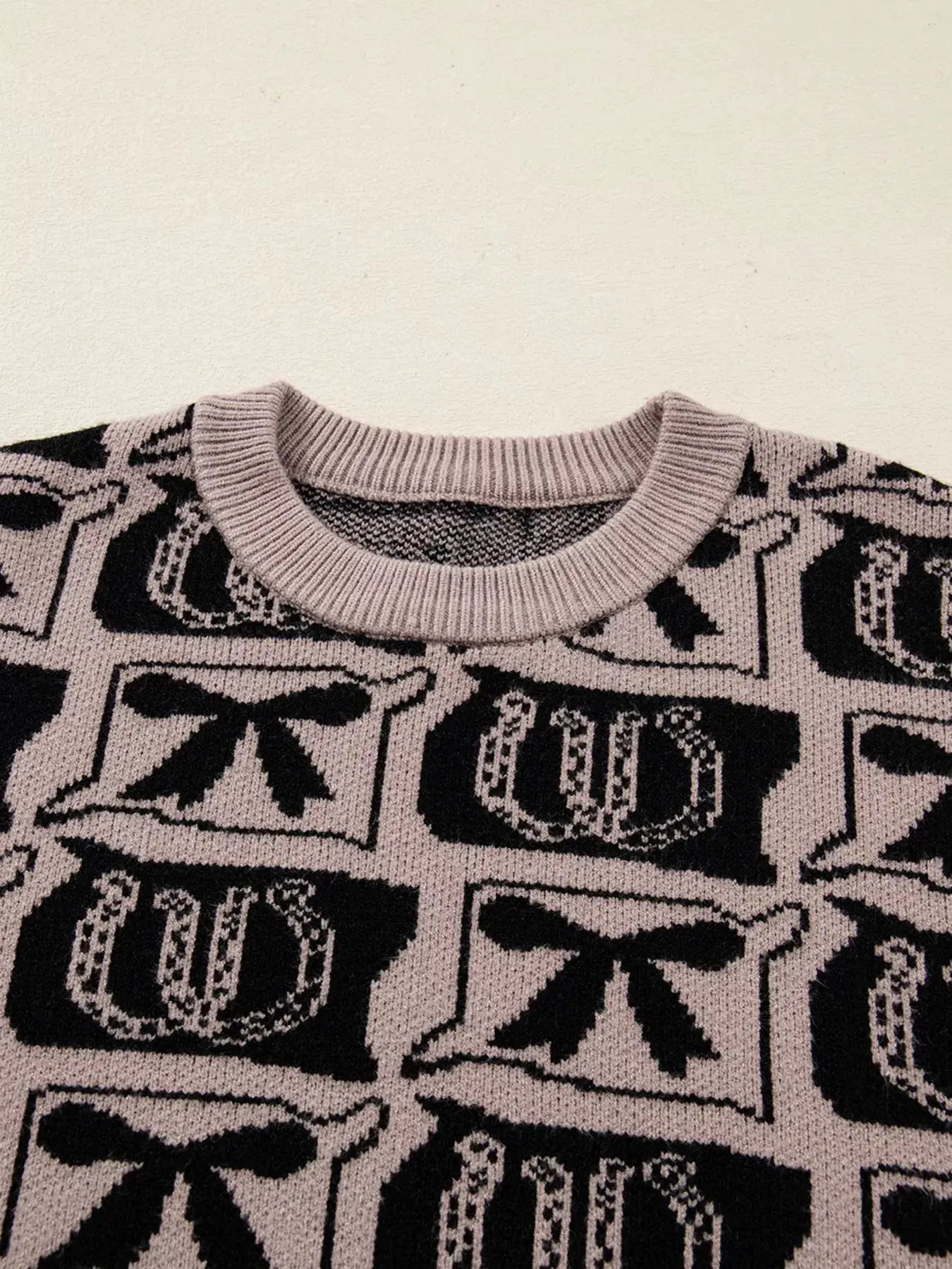 Bows & Horseshoes Pattern Round Neck Sweater, pink-beige knit with black bow and horseshoe motifs