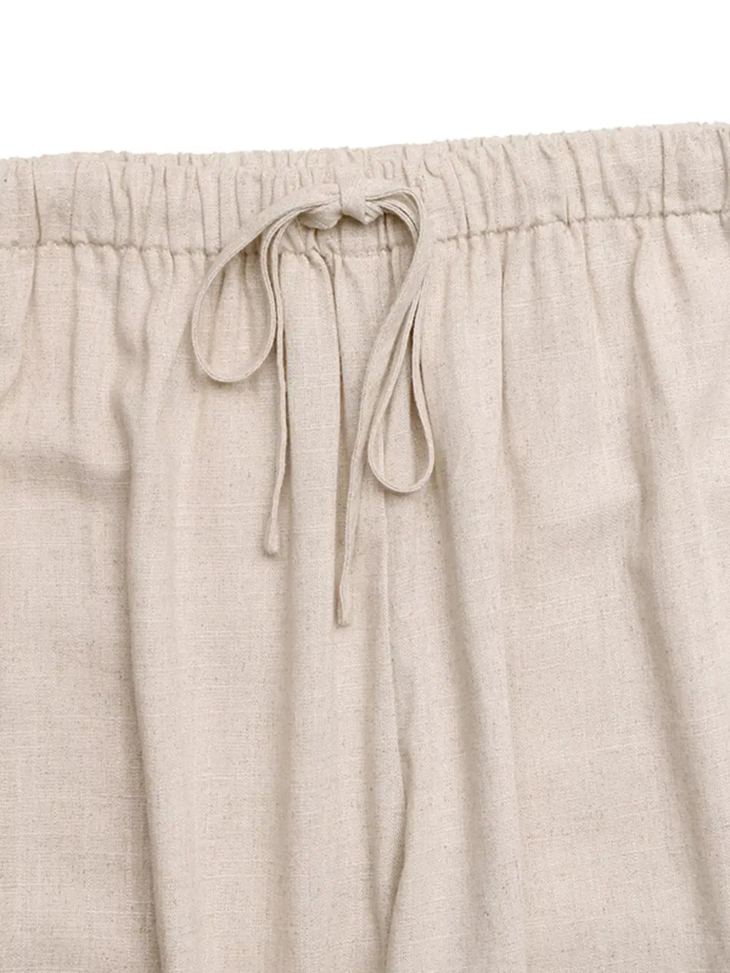 Drawstring wide-leg pants in cream linen-like fabric with elastic waistband and tie.