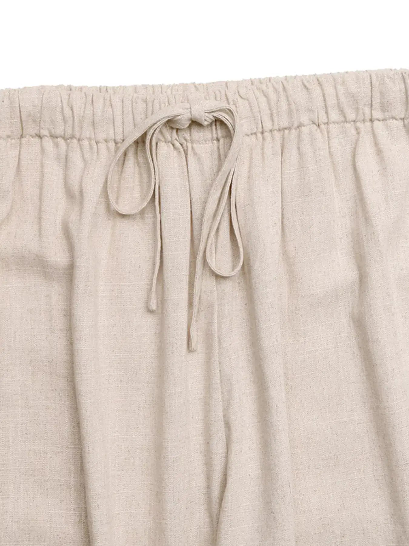 Drawstring wide-leg pants in cream linen-like fabric with elastic waistband and tie.