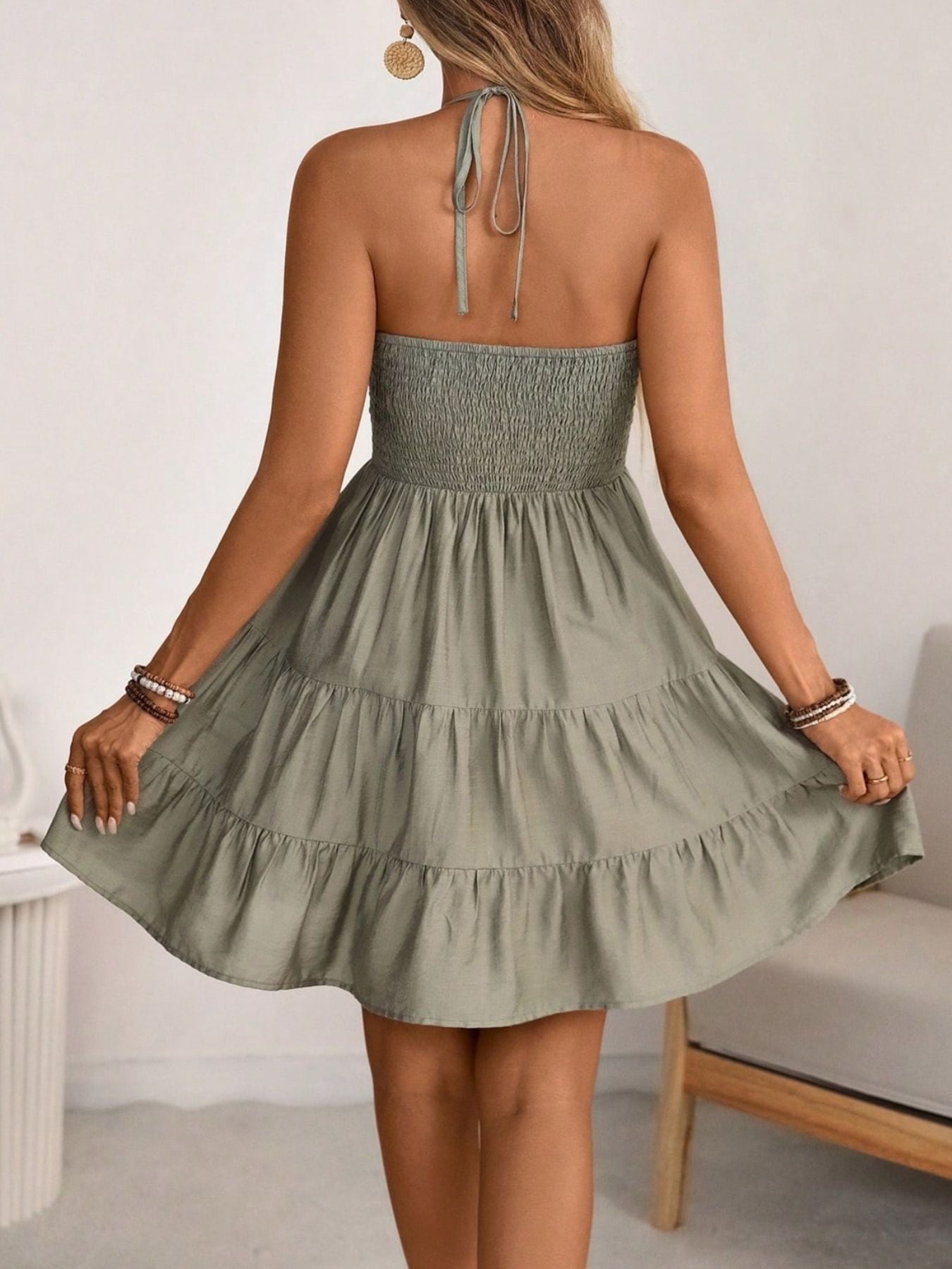 Smocked Halter Neck Tiered Dress in sage green; back view with smocked bodice and layered ruffle skirt