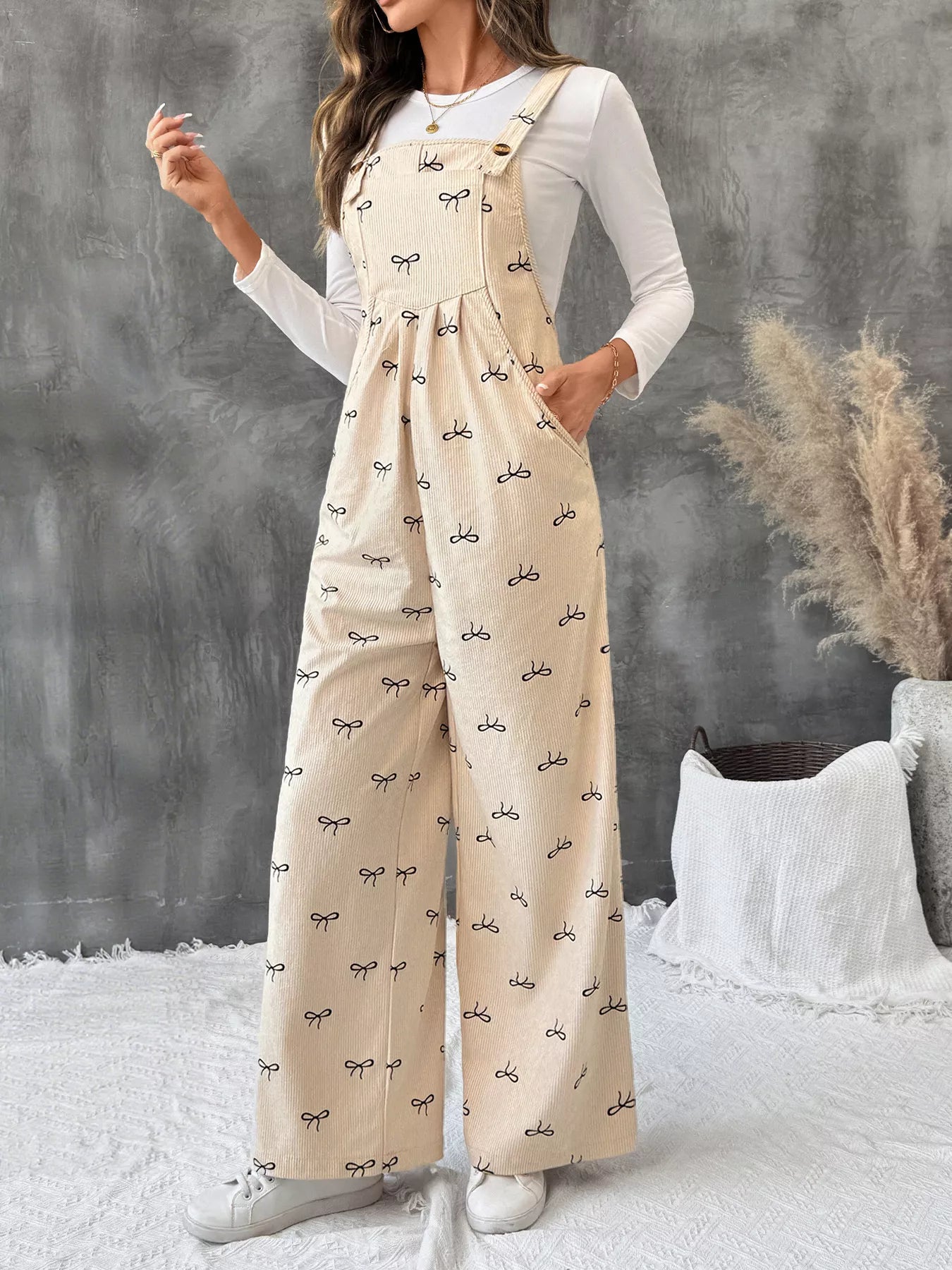 Bow Wide Leg Corduroy Overalls in beige with black bow print and pockets by Belle Bijouix