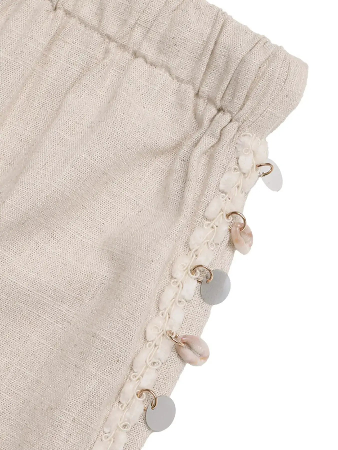 Drawstring wide-leg pants in beige linen with decorative shell and coin trim along the side seam