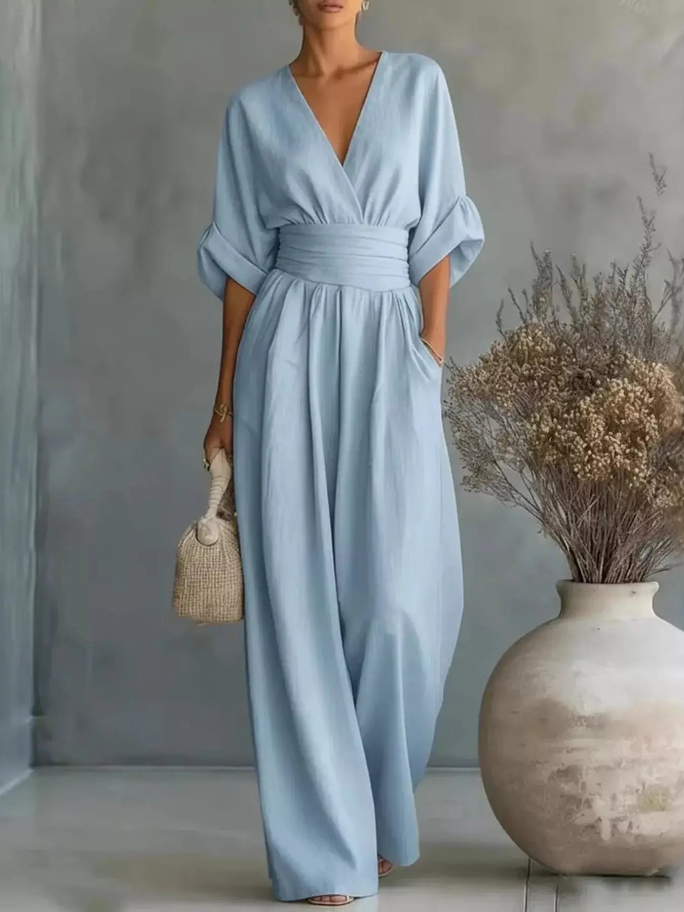 One-Pieces: Belle Bijouix light-blue wrap jumpsuit with V-neck, wide-leg silhouette, and voluminous puff sleeves.