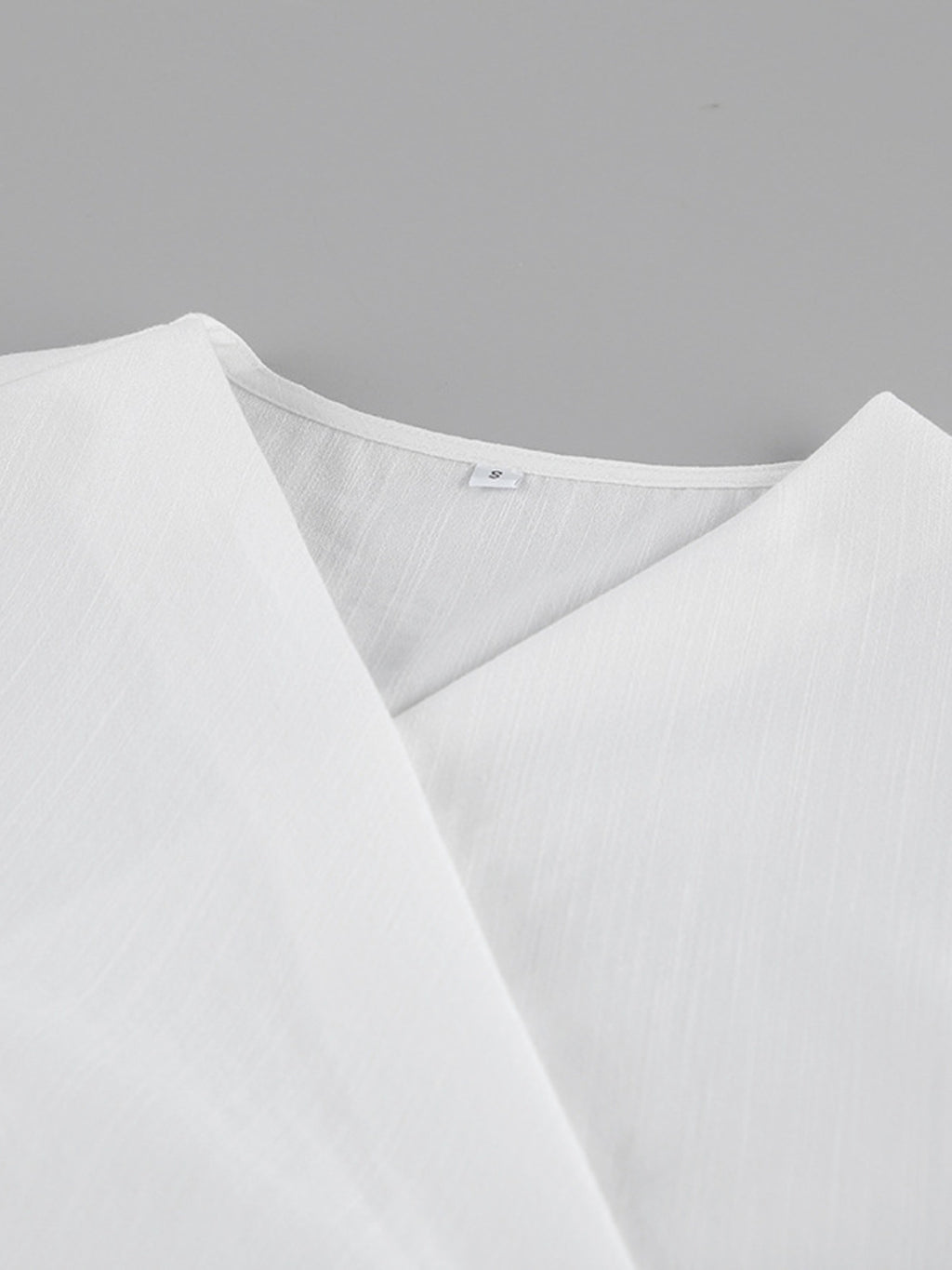 Wrap Top & Wide Leg Pants Set white fabric, collar detail, size S label visible.