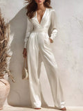 Satin Long Sleeve Wide Leg Jumpsuit in ivory with wrap-front bodice and waist sash.