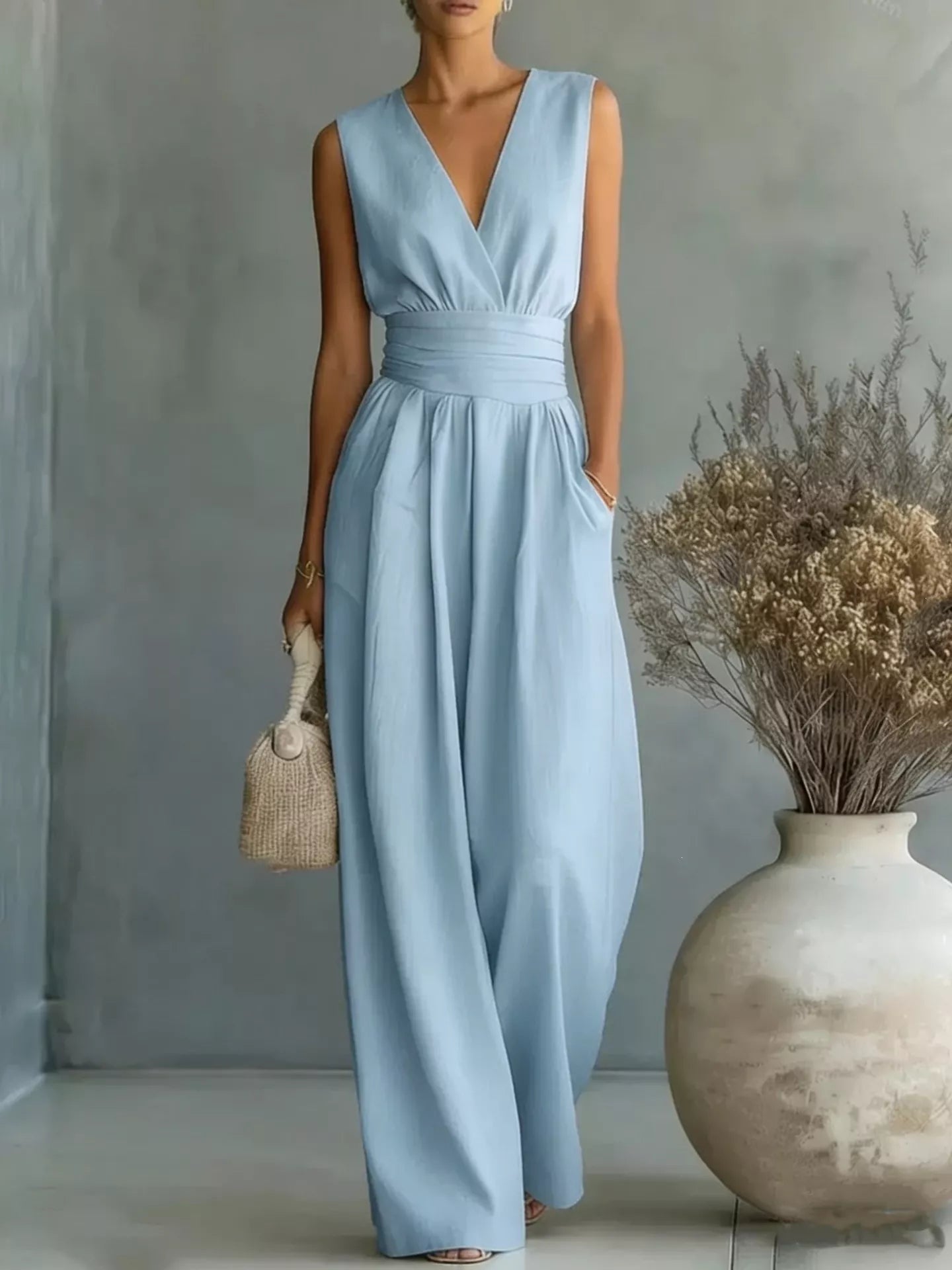 Full-size sleeveless light-blue jumpsuit with wide legs, ruched waistband, and pockets