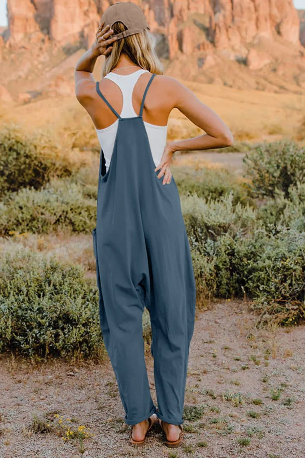 Double Take full-size V-neck sleeveless jumpsuit with pockets in blue, back view.