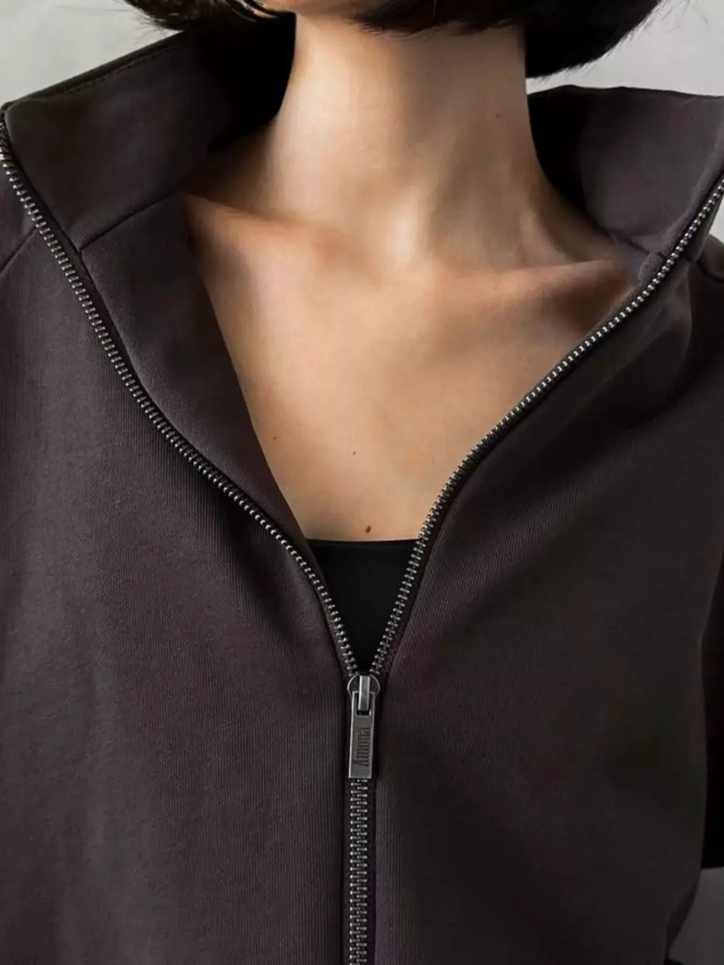 Two-piece Belle Bijouix zip-up long-sleeve activewear top; dark charcoal with metal zipper.