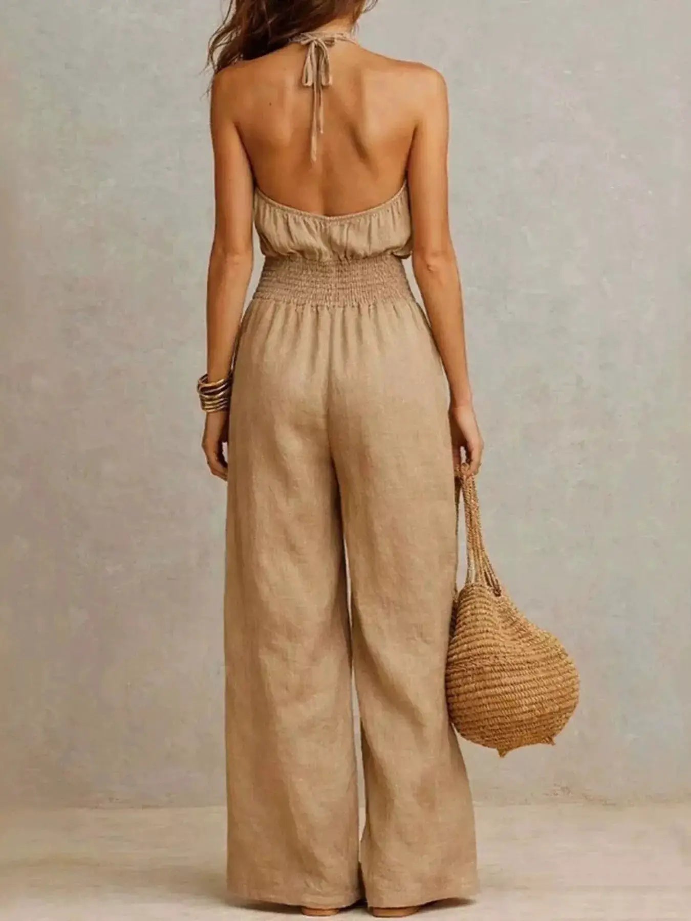 Smocked Halter Neck Wide-Leg Jumpsuit in beige linen-like fabric, back view by Trendsi