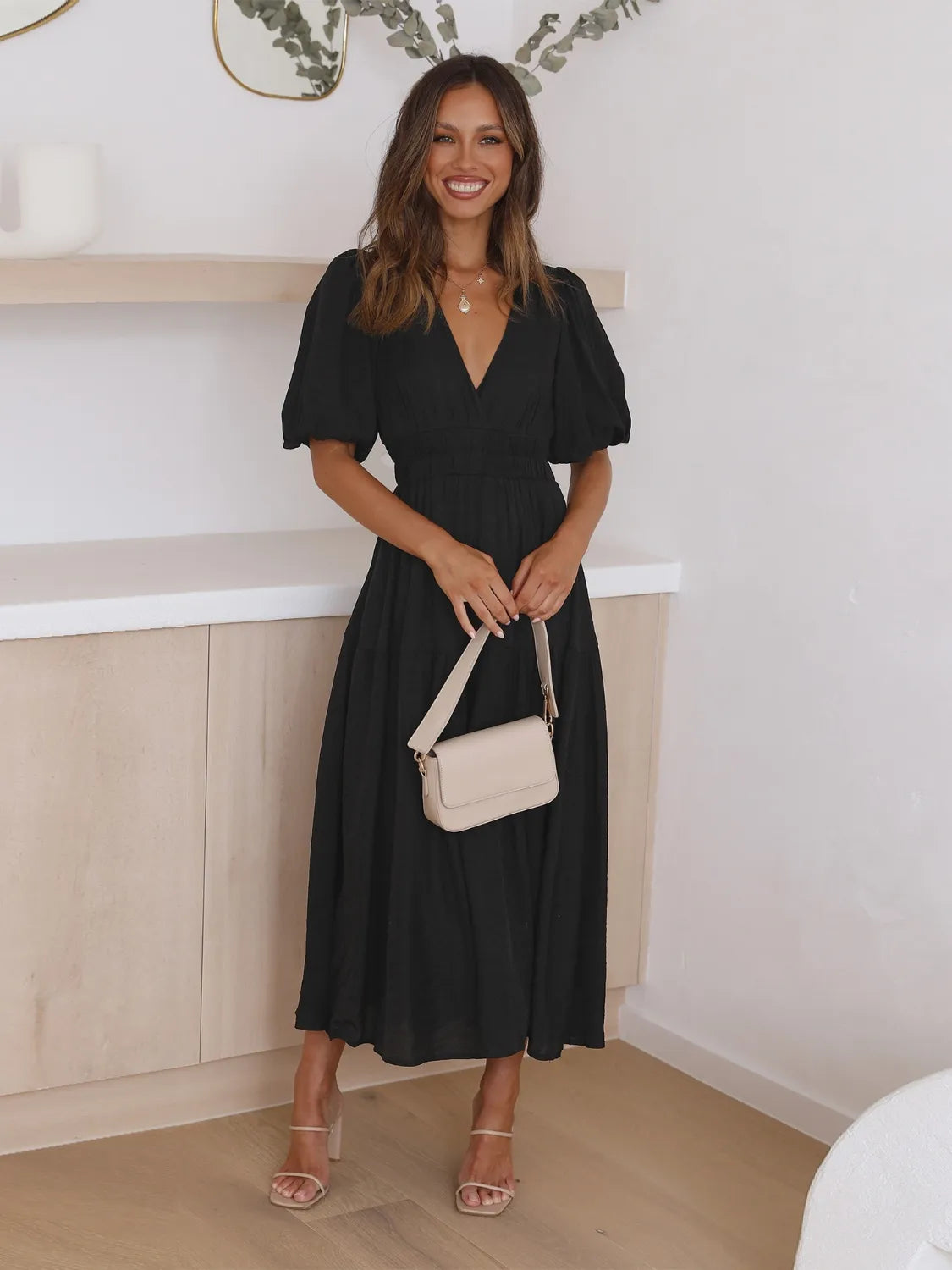 Tiered surplice midi dress by Belle Bijouix, black with puff sleeves.