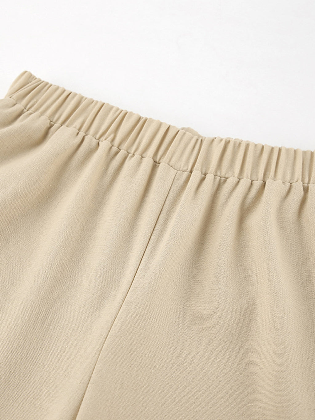 Sleeveless crop top and slit pants set in beige with an elastic waistband