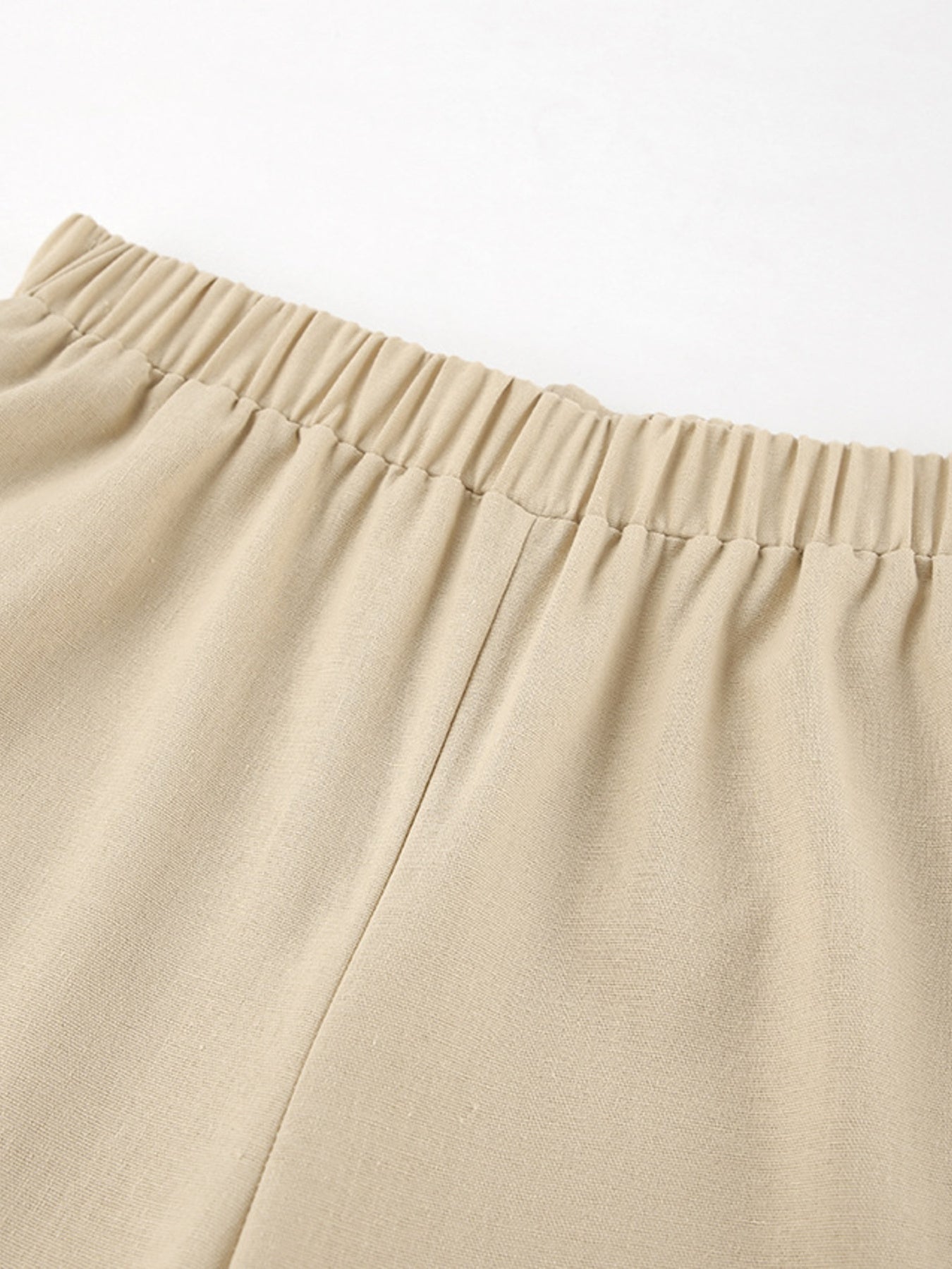 Sleeveless crop top and slit pants set in beige with an elastic waistband