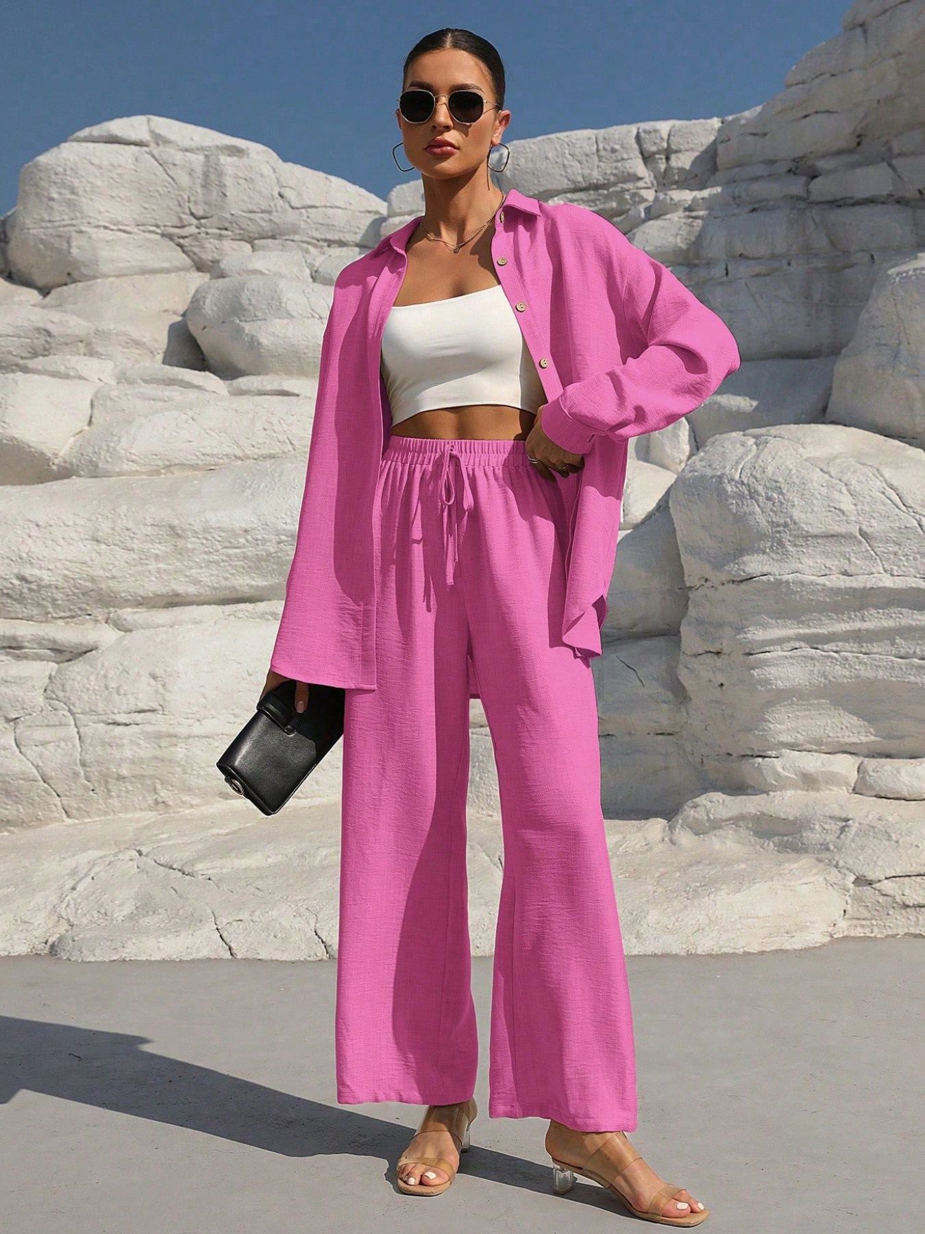 Button Up Long Sleeve Shirt and Pants Set in pink, worn by model with white crop top and sunglasses.
