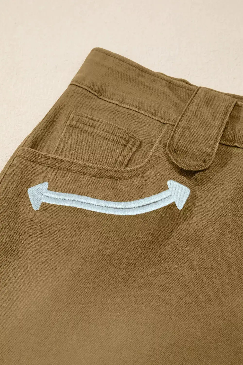Women's Western Denim Shorts by Belle Bijouix in tan denim with white curved arrow embroidery.