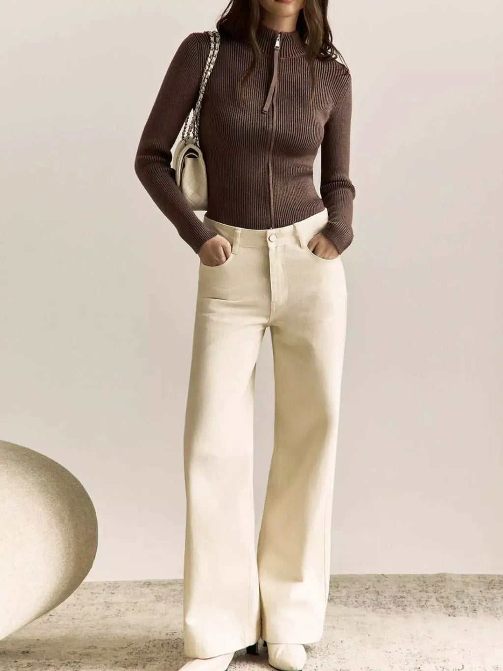 Ribbed Knit Zip-Up Cardigan top in brown with front zipper, styled with cream wide-leg pants.