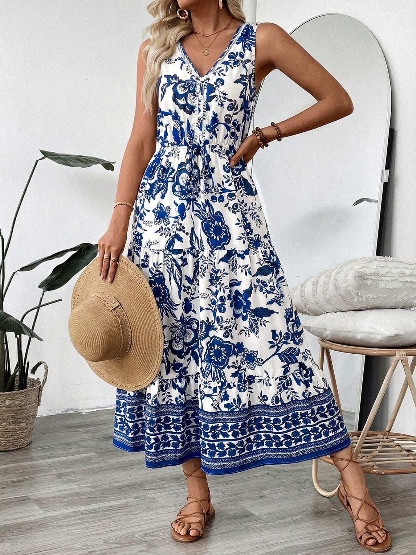 Bellebijouix floral print sleeveless V-neck midi dress, blue and white, with buttoned waist belt and tiered skirt