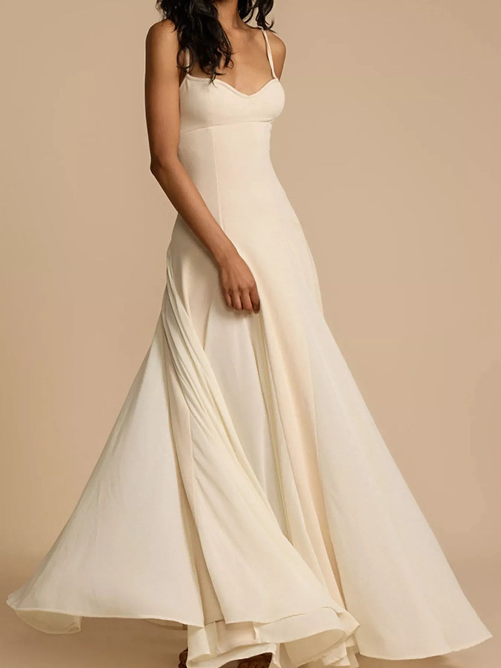 Sweetheart-neck spaghetti-strap maxi dress in ivory, flowing silhouette.