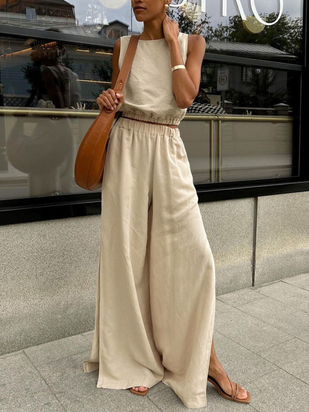 Belle Bijouix Sleeveless Crop Top and Slit Pants Set in beige with tan crossbody bag