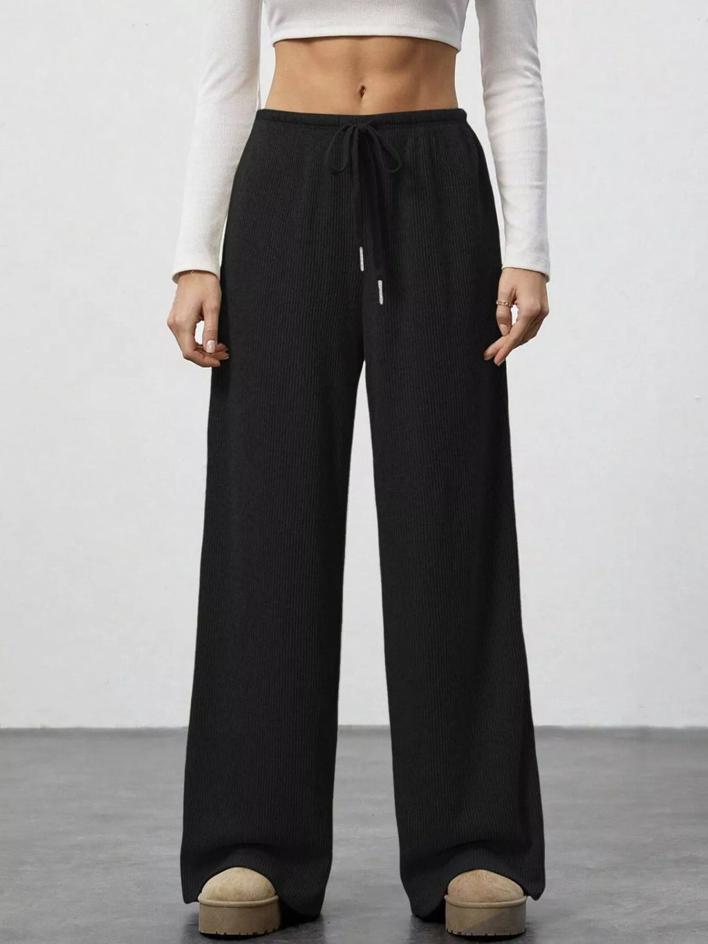 Relaxed fit drawstring pants in black ribbed knit with pockets, active wear joggers.