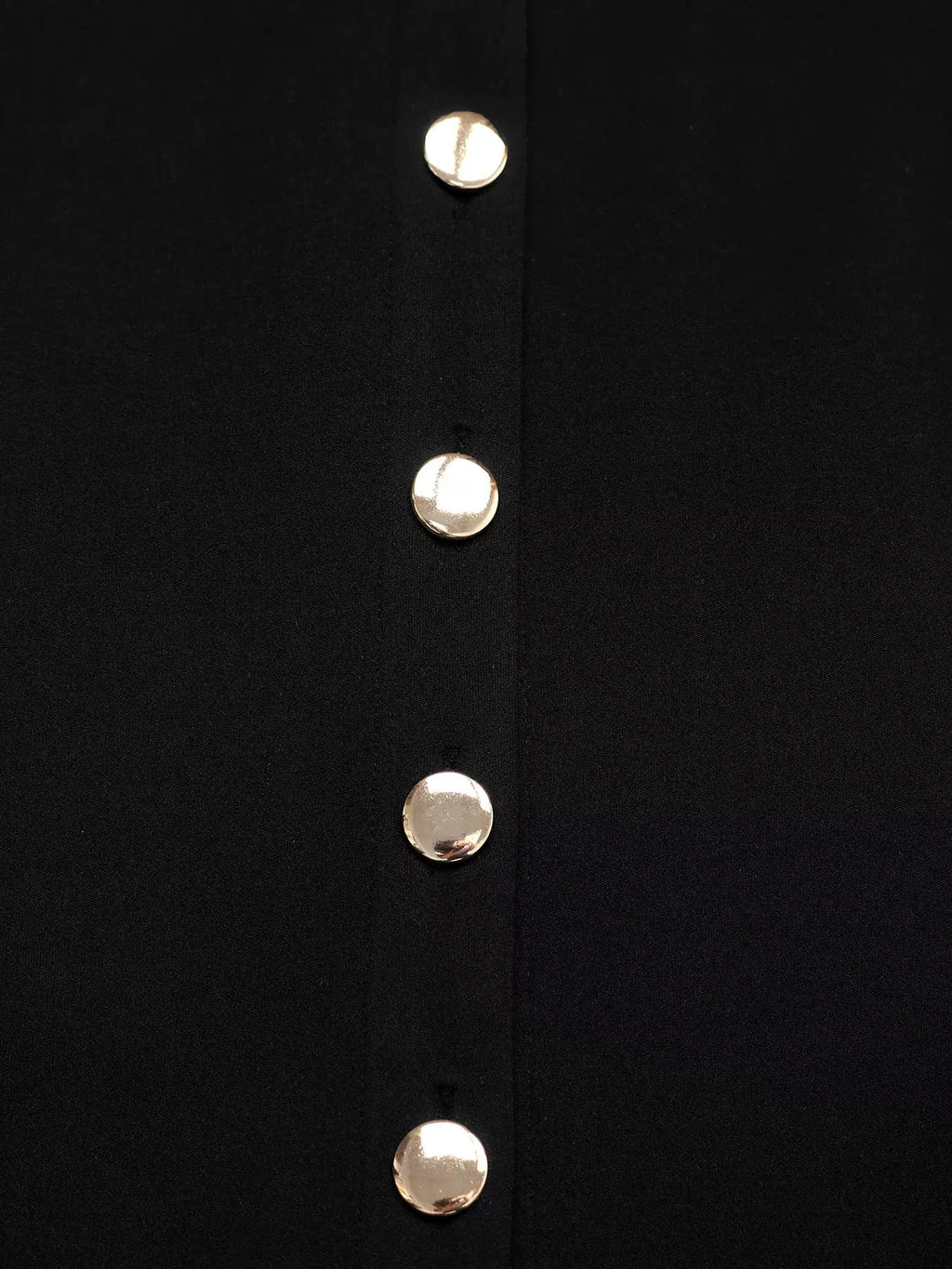 Sleeveless button-front dress in black fabric with silver round buttons.