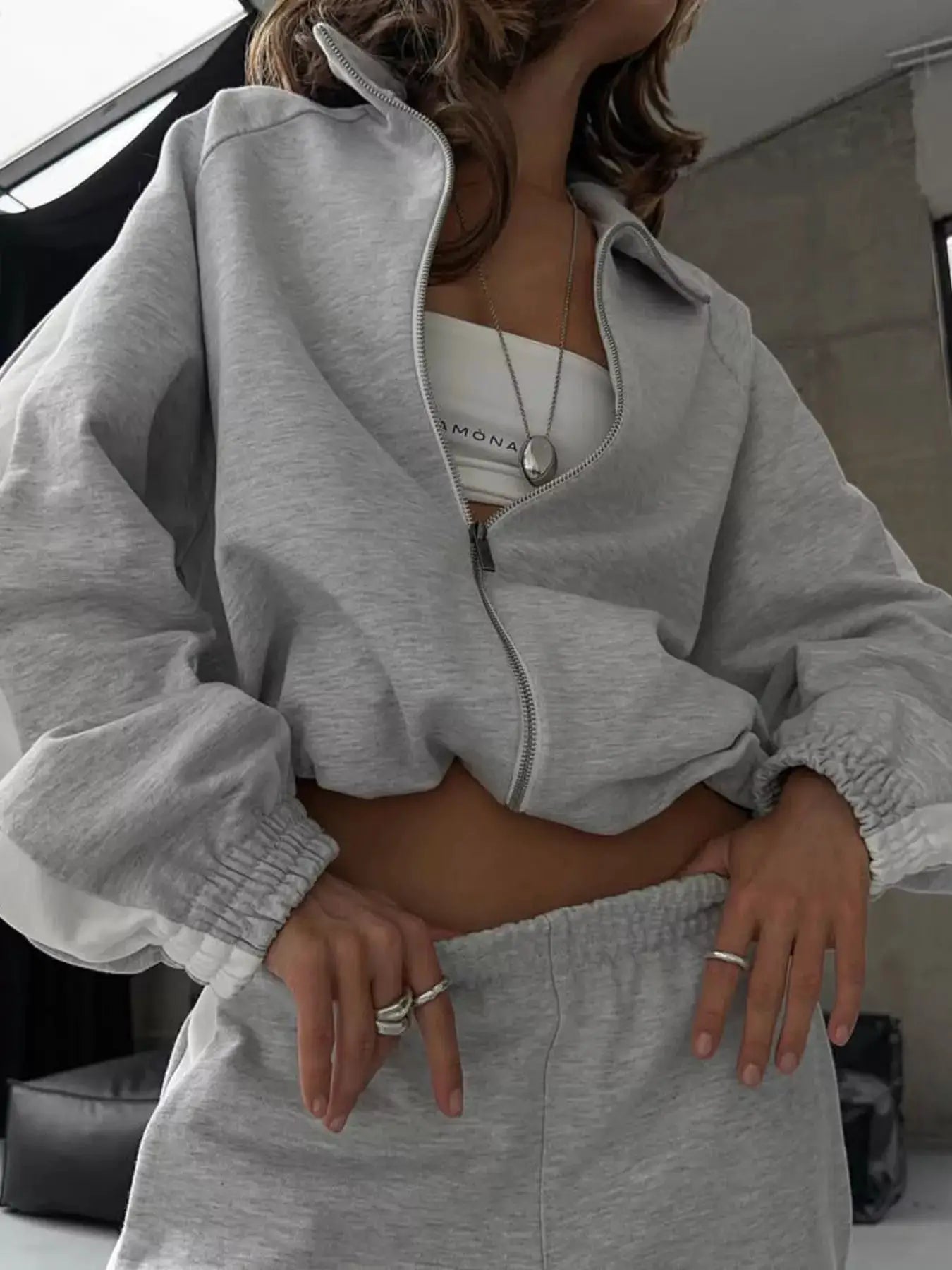 Two-Piece Zip-Up Long Sleeve Outerwear and Pants Set in light gray by Belle Bijouix; zip hoodie with matching joggers.